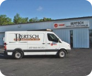 a work van with the Bertsch logo on the side parked in front of a warehouse